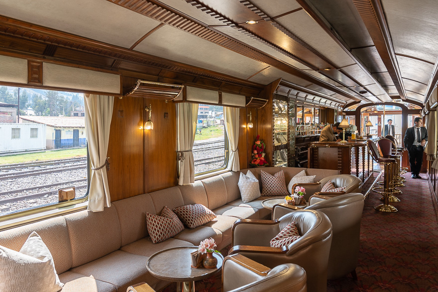 Luxurious train interior with seating and bar area.