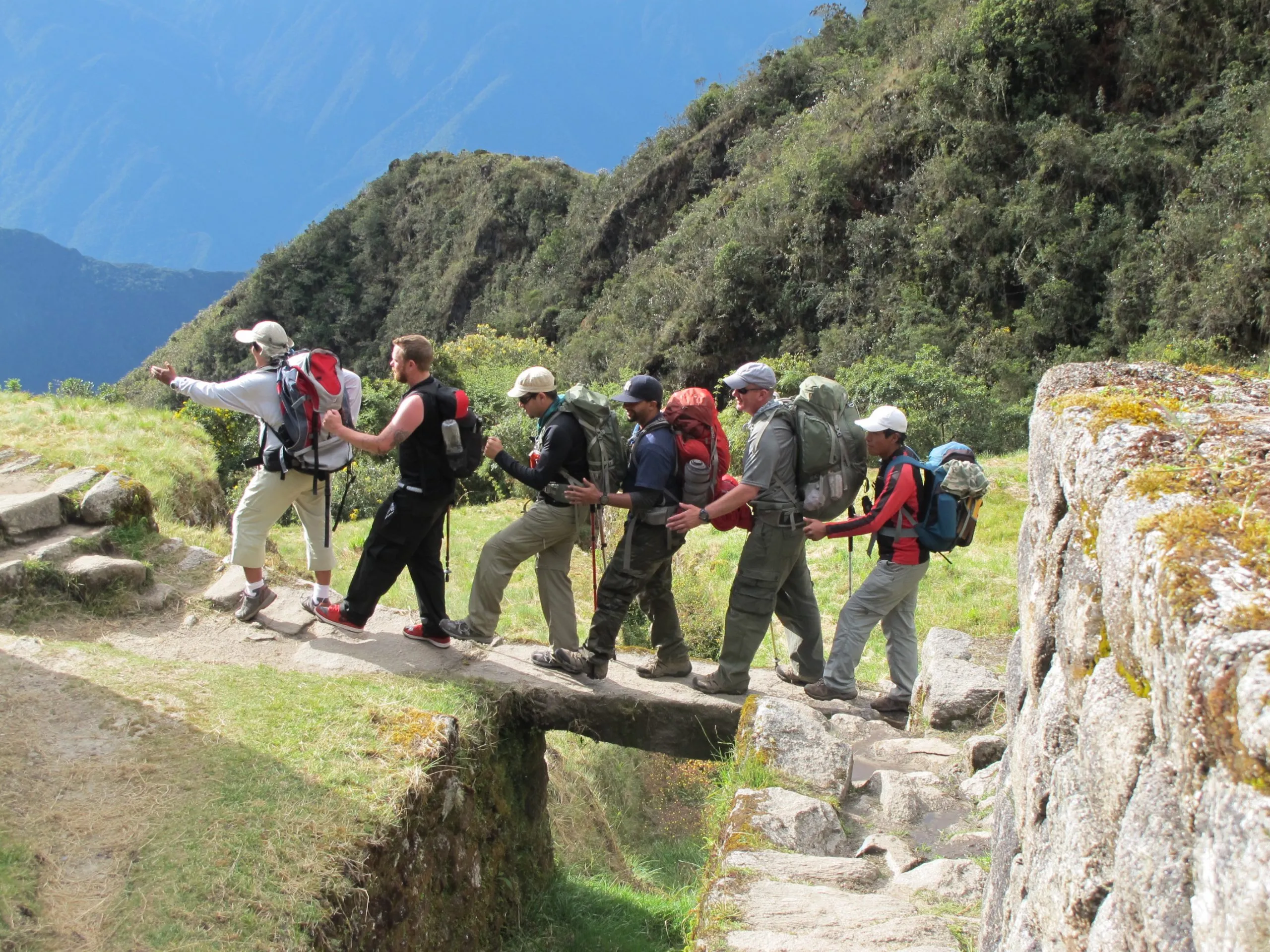 Hikers crossing Inca Trail bridge in Peru