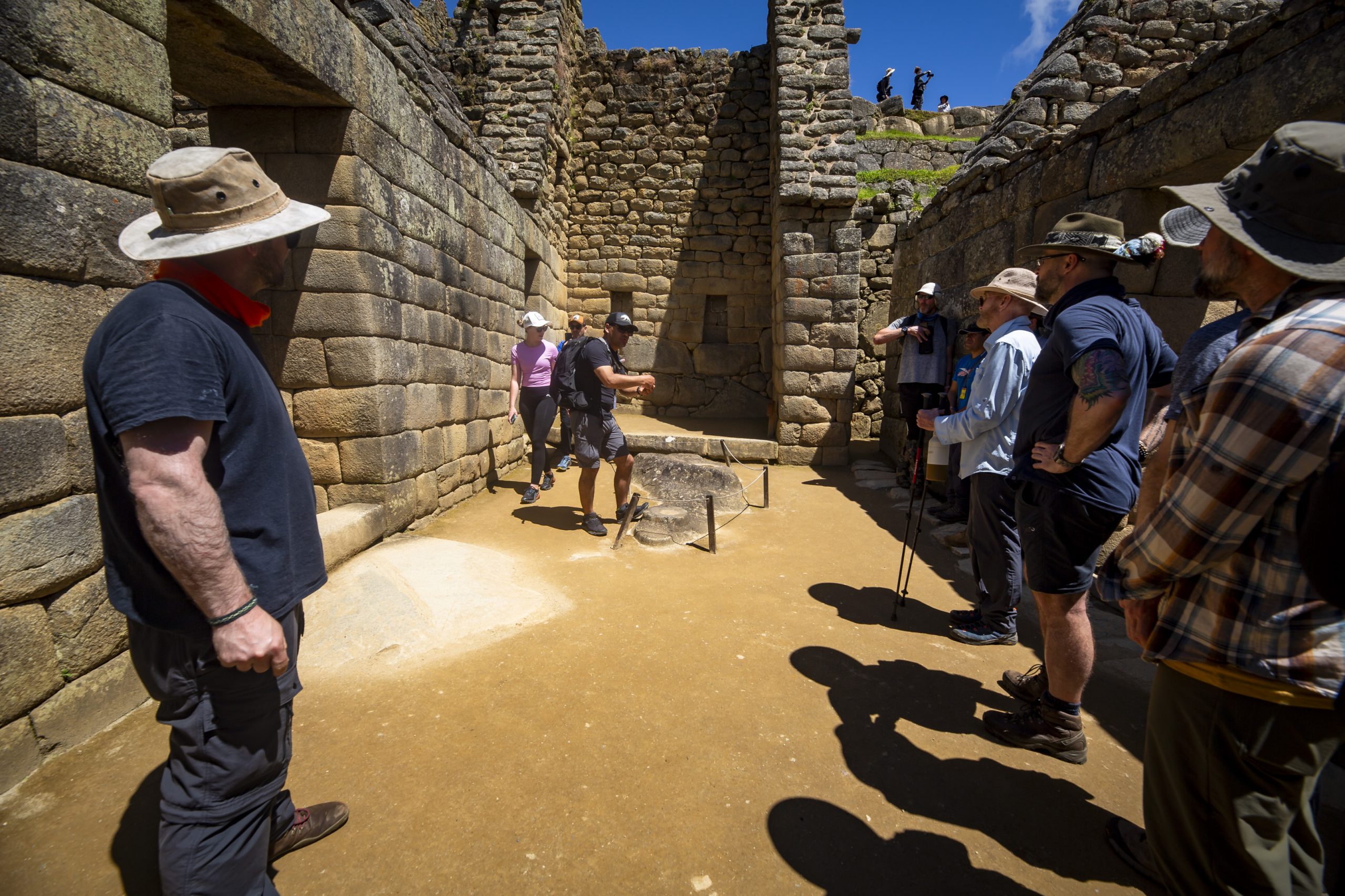 _S7A6205 - Copy Tourists explore ancient Inca ruins under the sun.