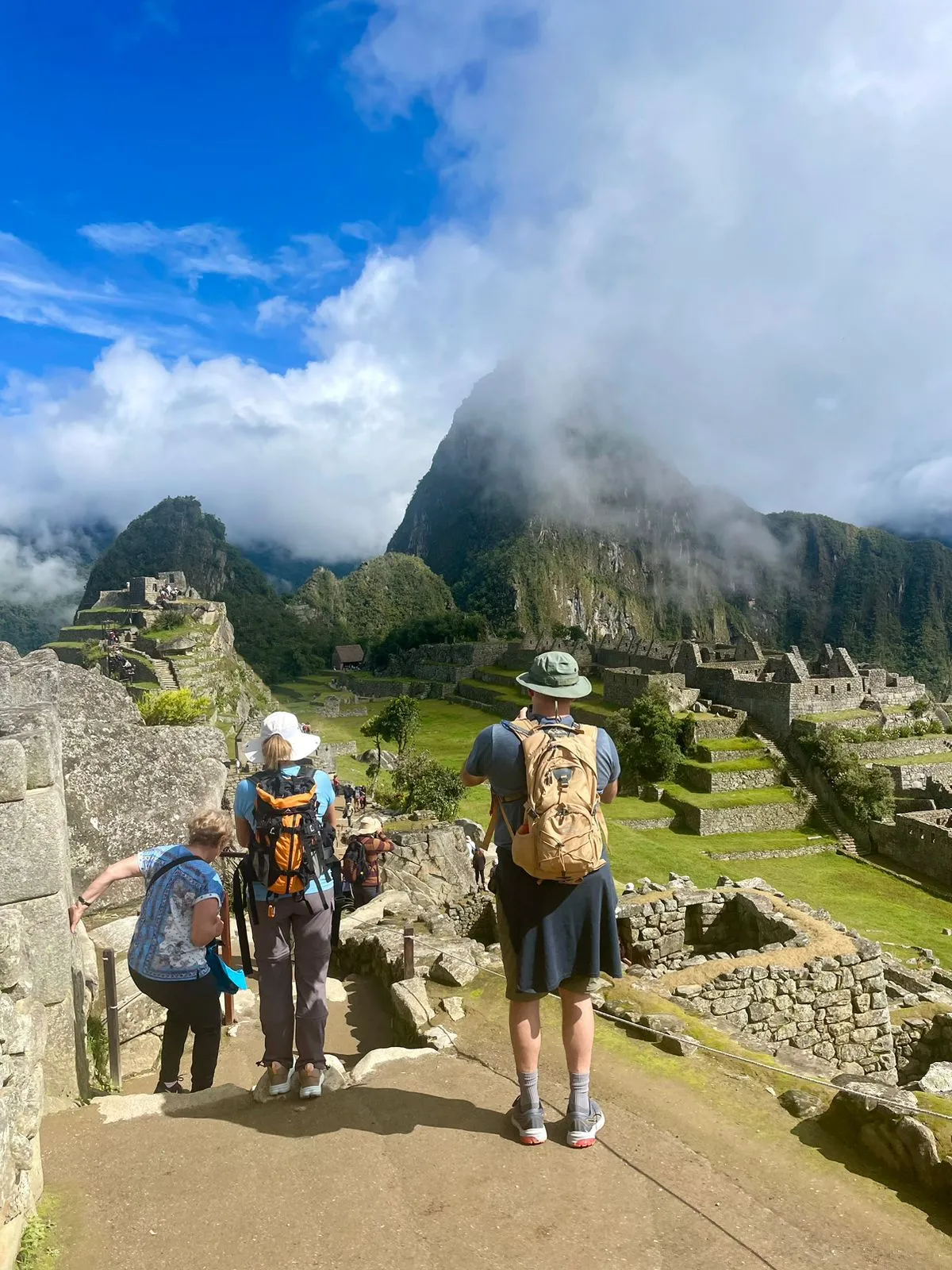 Tourists exploring Machu Picchu's ancient ruins and mountains.