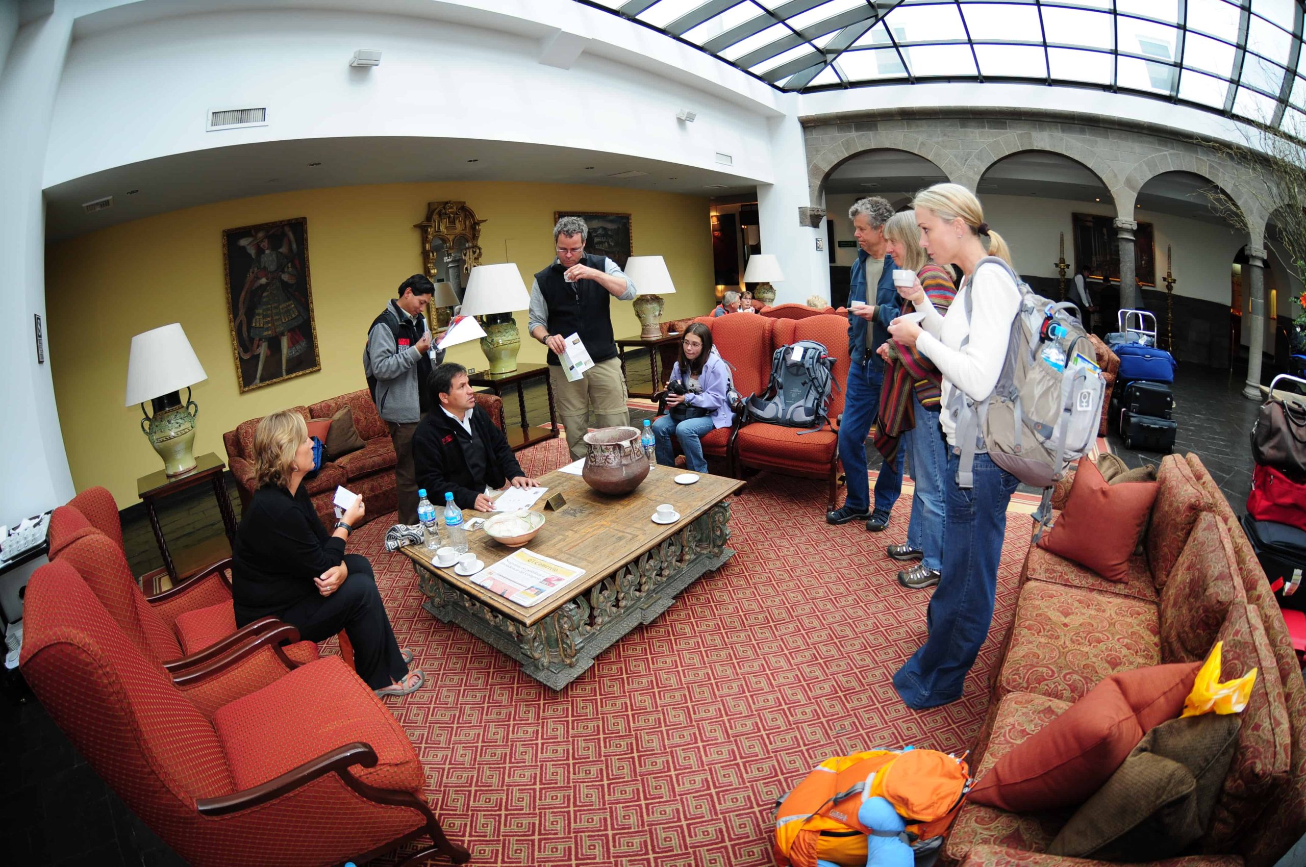 hotel2 Group gathered in hotel lobby with luggage.