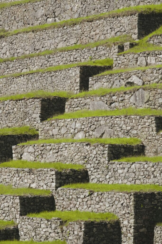 A stone structure with grass growing on it A stone structure with grass growing on it